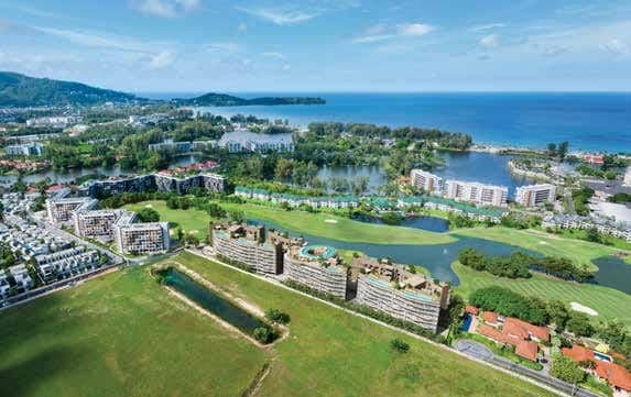 Aerial view over the buildings, golf course and sea