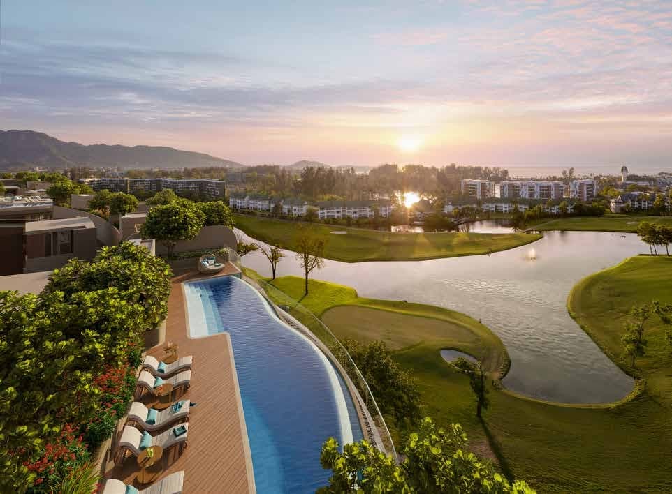 Pool and loungers above the golf course at sunset