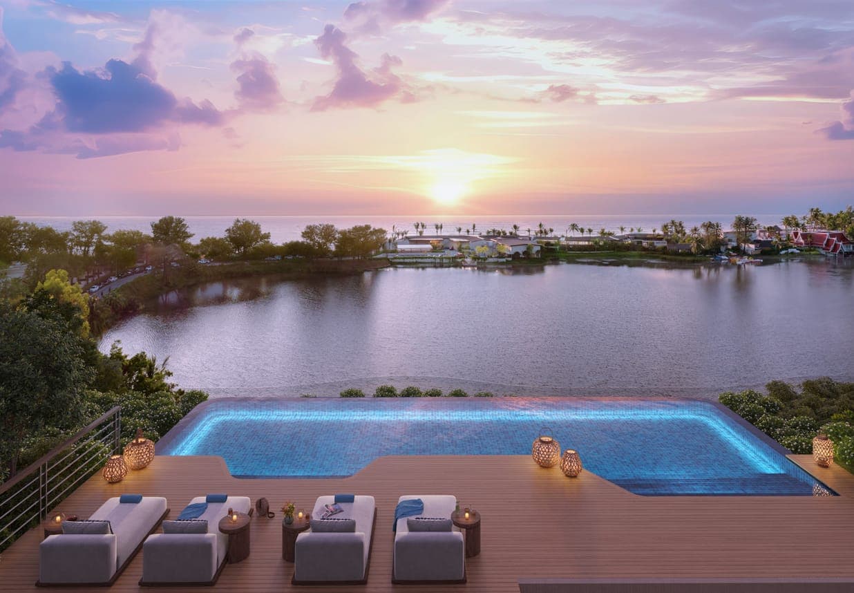 Rooftop pool and loungers at sunset over the lagoon