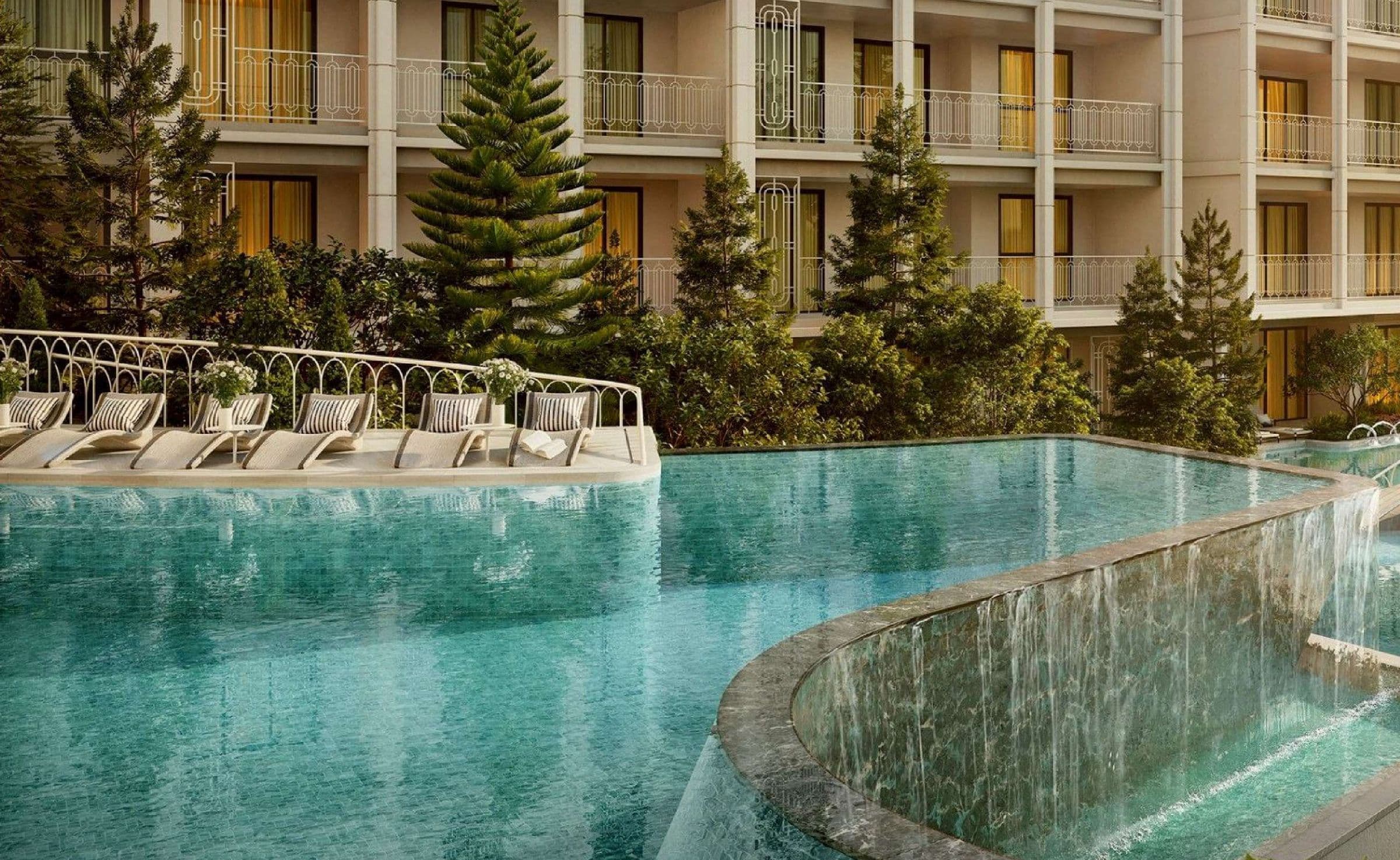 Biancana's cascade pool with loungers beneath the residential buildings