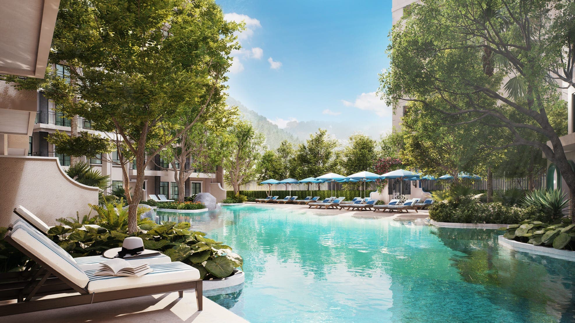 The Katabello lagoon pool with loungers, gardens and mountains beyond
