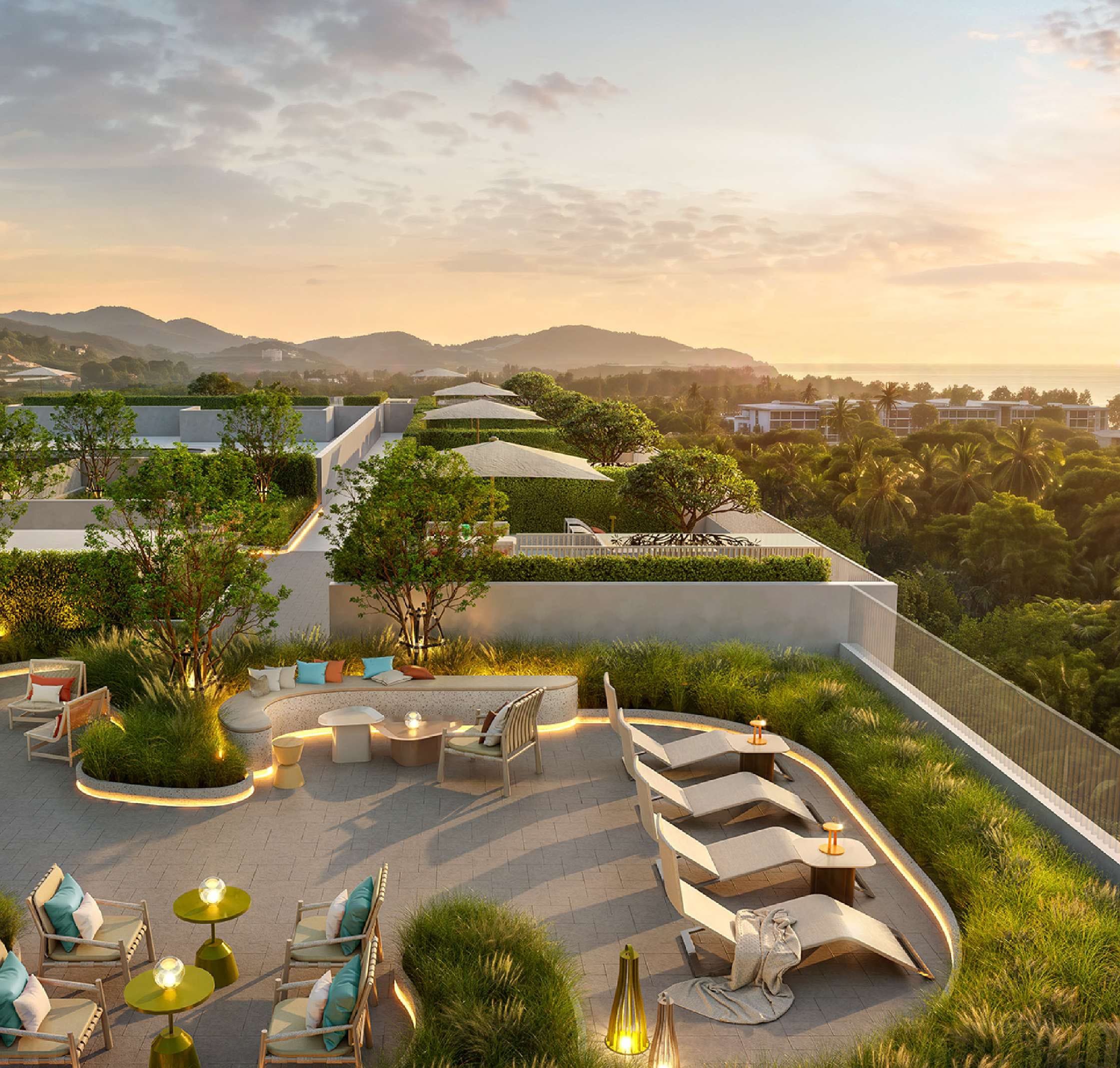 Rooftop garden lounge at golden hour overlooking Karon