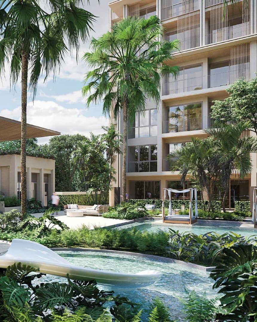 Sudara residential building rising above palms and a garden pool