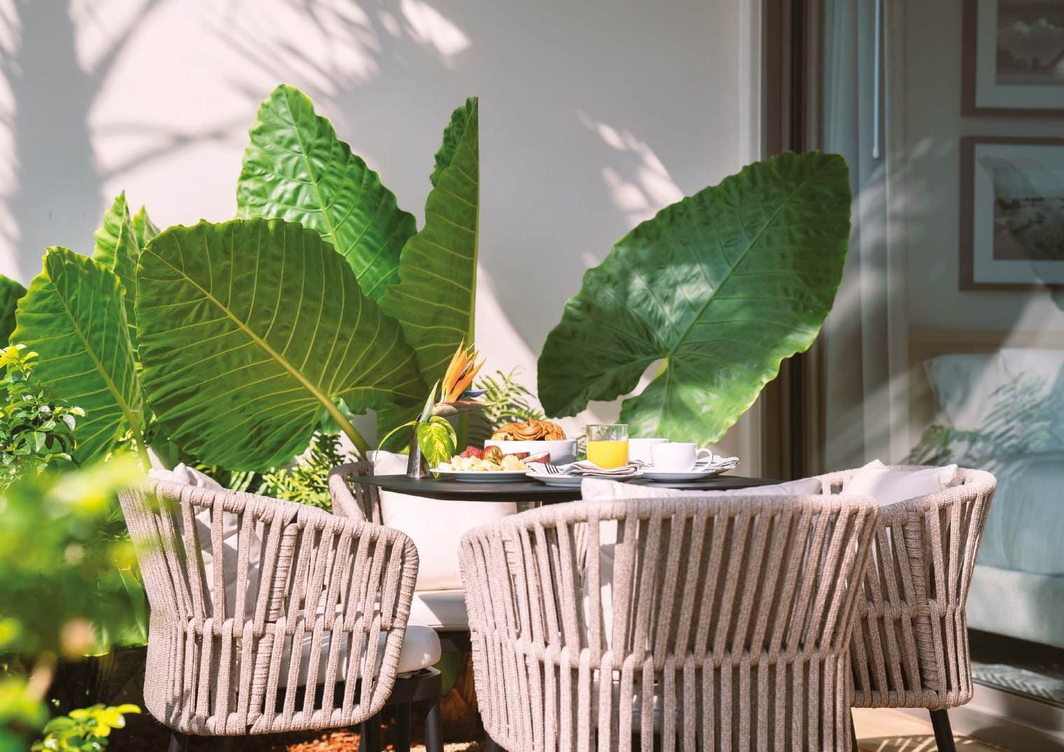 Terrace dining among tropical leaves