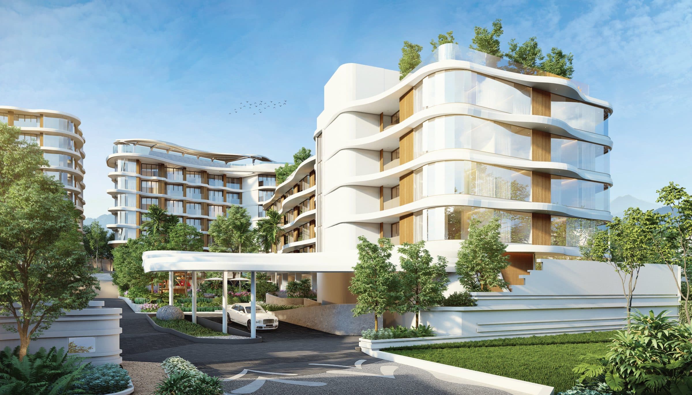 Vibe Residence arrival with curved white façade and covered drop-off