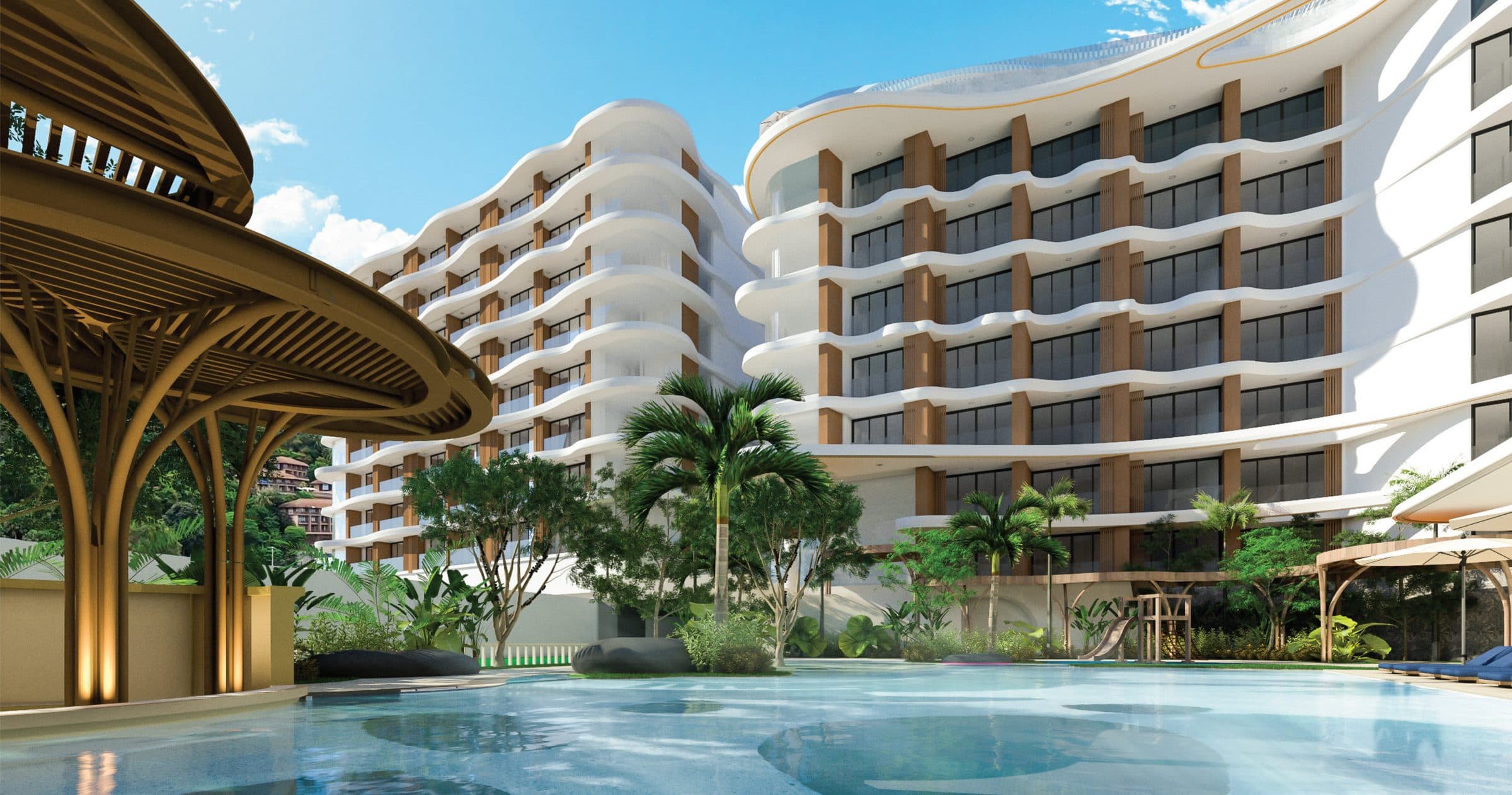 Vibe Residence buildings with curving white balconies above the main pool