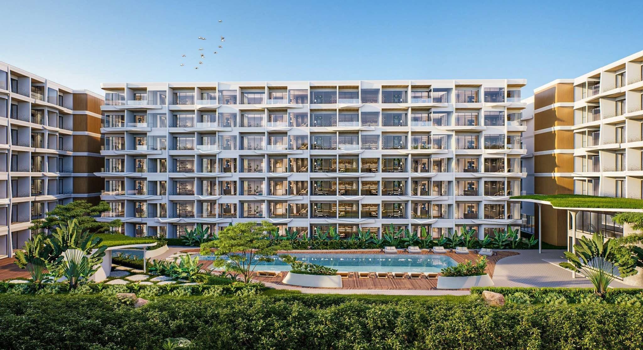 Wallaya Residence Nai Harn buildings behind landscaped gardens and the pool