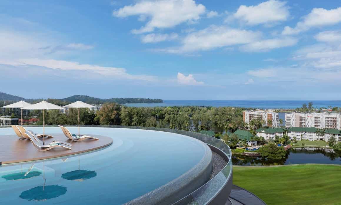 Ring-shaped rooftop infinity pool with loungers and parasols above the golf course