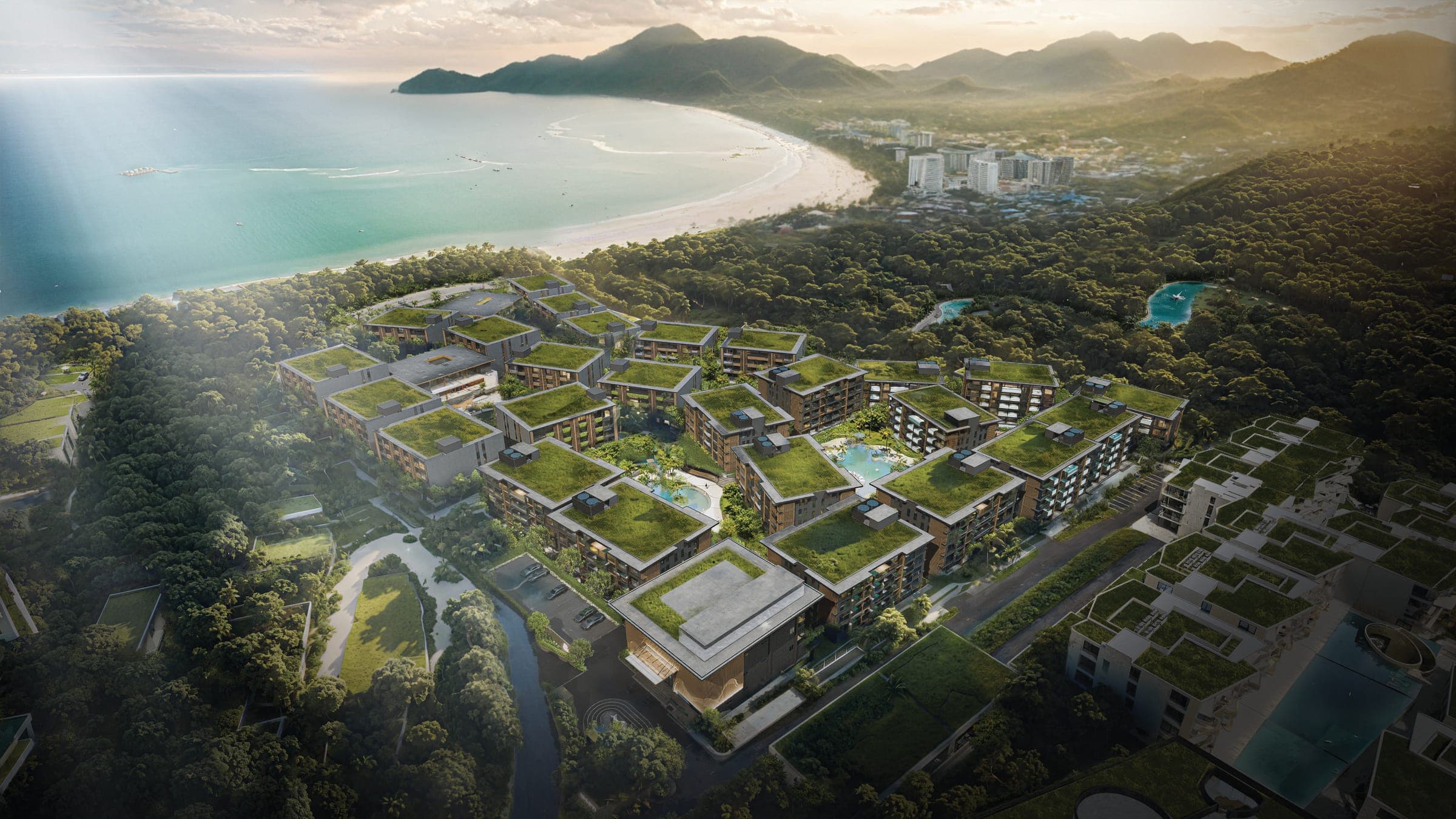 Aerial render of Ascott Abov Patong Phuket's green-roofed low-rise buildings with Patong Bay behind