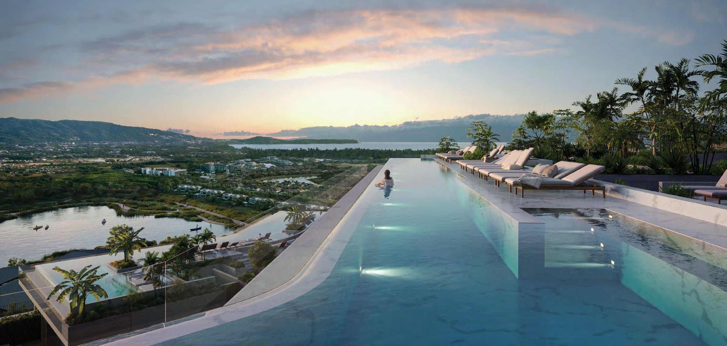 Rooftop infinity pool with loungers looking over the lagoons at sunset