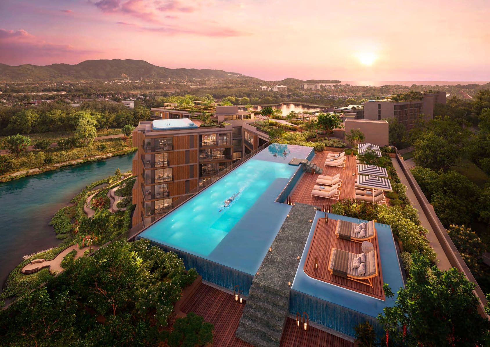 Rooftop infinity-edge pool and sun deck at sunset above the lagoon
